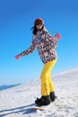 Young woman snowboarding on hill. Winter Royalty Free Stock Photo