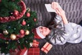Young woman on sofa with Christmas presents Royalty Free Stock Photo