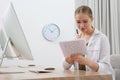 Young woman solving sudoku puzzle at workplace in office Royalty Free Stock Photo