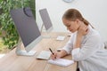 Young woman solving sudoku puzzle at workplace in office Royalty Free Stock Photo