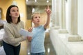 Woman and boy observing sculptures exhibition Royalty Free Stock Photo