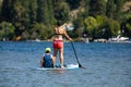 Young woman with son paddle boarding