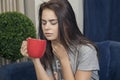 Young woman with a sore throat drinking tea Royalty Free Stock Photo