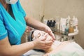 Young woman In Spa Salon With Facial Mask