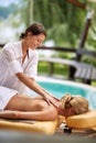 Young woman at spa and wellness back massage treatment Royalty Free Stock Photo