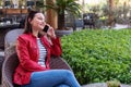 Young woman speak with phone and have a happy face in an elegance cafe.