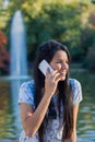 Young woman speaking on the phone in the park