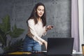 Young woman specialist preparing workplace in office. Girl powering on laptop to start working. Manager using computer for