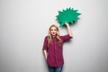 Young woman with speech bubble on grey background