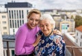 Young woman spending time with her elderly grandmother at home