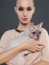 Young woman with Sphynx cat