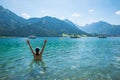 young woman splashes in the cool water of lake achensee, summer scene Royalty Free Stock Photo