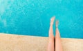 Young woman splashing feet in pool