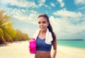 Young woman with sport bottle on seaside