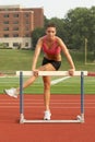 Young Woman in Sports Bra Warming-up on Hurdle