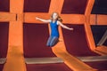 Young woman sportsman jumping on a trampoline in fitness park an Royalty Free Stock Photo