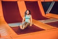 Young woman sportsman jumping on a trampoline in fitness park an Royalty Free Stock Photo