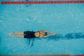 Young woman swimmer swims in swimming pool Royalty Free Stock Photo