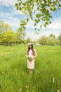 Young woman in spring park. Girl on green grass Royalty Free Stock Photo