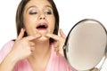 Young woman squeezes her pimples in front the mirror Royalty Free Stock Photo