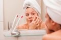 Young woman squeezing acne on her face Royalty Free Stock Photo