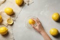 Young woman squeezing lemon with juicer Royalty Free Stock Photo