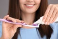 Young woman squeezing toothpaste on brush, closeup Royalty Free Stock Photo