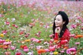 Young woman stand on Flower Sea and listening to music with headphones Royalty Free Stock Photo