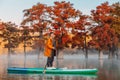 Young woman on stand up paddle board at the lake with Taxodium trees. Woman on SUP board Royalty Free Stock Photo