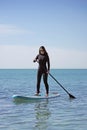 Young Woman Stand Up Paddle Boarding