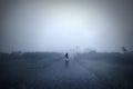 Young woman standing alone in the misty morning Royalty Free Stock Photo