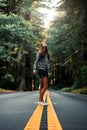 Young Woman Standing in Amazement in Center of Road
