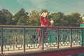 Young woman standing on bridge and looking at water Royalty Free Stock Photo