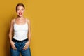 Young woman standing on bright yellow background. Positive emotion Royalty Free Stock Photo