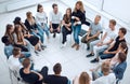 Young woman standing in a circle of business training participants Royalty Free Stock Photo