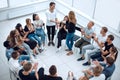 Young woman standing in a circle of business training participants Royalty Free Stock Photo