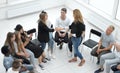 Young woman standing in a circle of business training participants Royalty Free Stock Photo