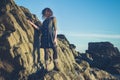 Young woman standing on a cliff