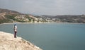 Young woman standing at the edge of a cliff enjoying the sea scenery. Pissouri coastline Limassol Cyprus