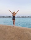 Young woman standing and enjoying the sun