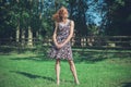 Young woman standing in field by fence on summer day Royalty Free Stock Photo