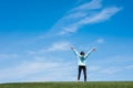 Young woman standing in field of green grass Royalty Free Stock Photo