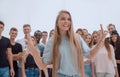 young woman standing in front of a casual group of young people Royalty Free Stock Photo