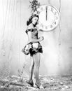 Young woman standing in front of a clock, celebrating New Years Eve Royalty Free Stock Photo