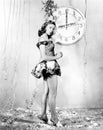 Young woman standing in front of a clock, celebrating New Years Eve Royalty Free Stock Photo