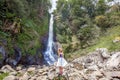 Young woman standing in front of Gitgit waterfall Royalty Free Stock Photo