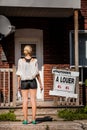 Young Woman standing in front of her new apartment