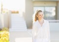 Young woman standing in front of house building Royalty Free Stock Photo