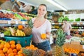 Young woman standing with full grocery cart during shopping Royalty Free Stock Photo