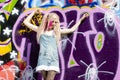 young woman standing at graffitti wall Royalty Free Stock Photo